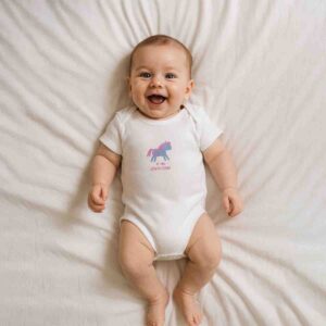 A toddler is wearing a Baby Unicorn Charm Bodysuit
