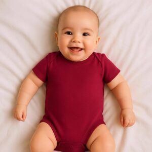 A toddler is wearing a berry pink minnie mouse baby bodysuit