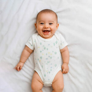 A toddler is wearing a forest hush baby bodysuit