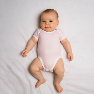 A toddler is wearing a gentle rose baby bodysuit