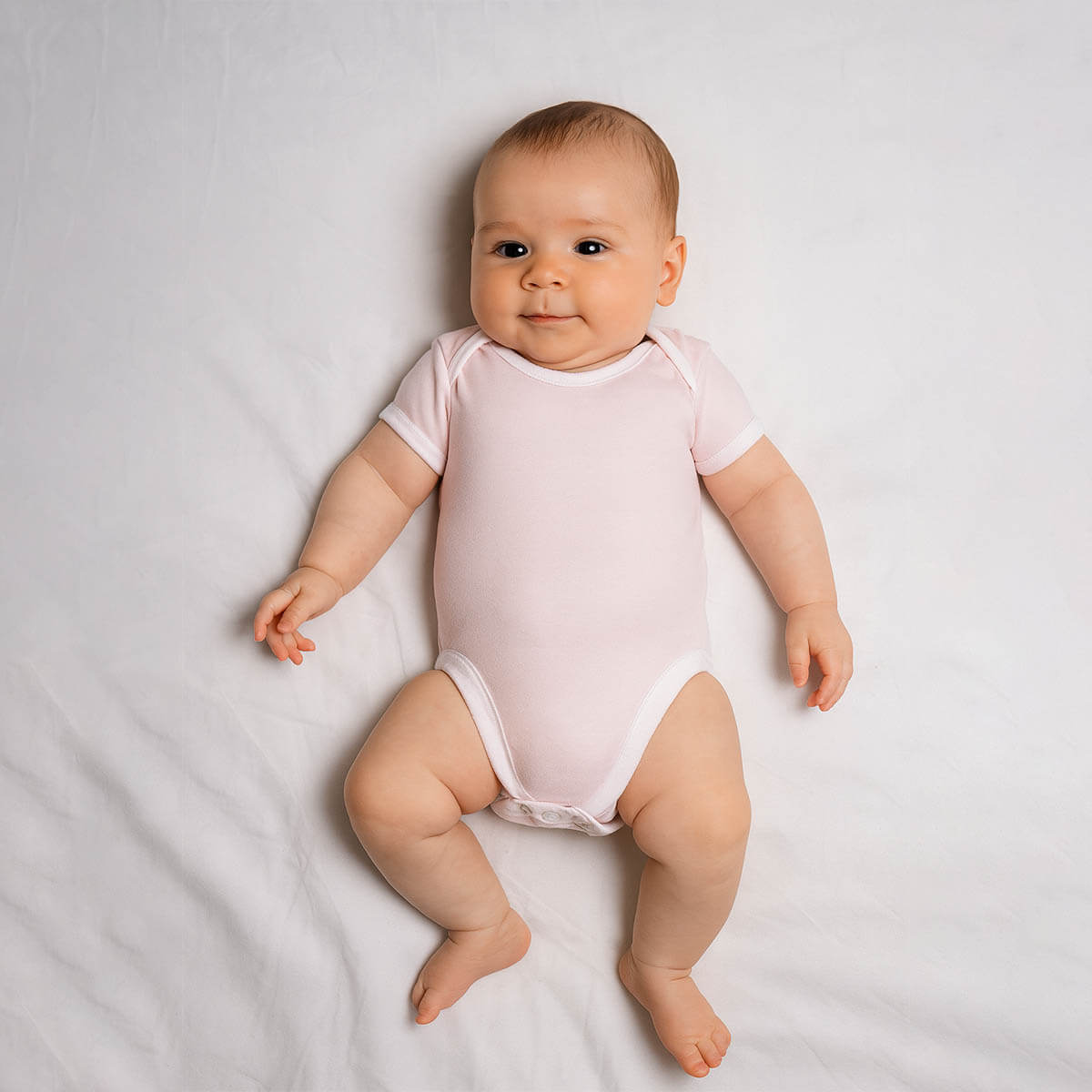 A toddler is wearing a gentle rose baby bodysuit