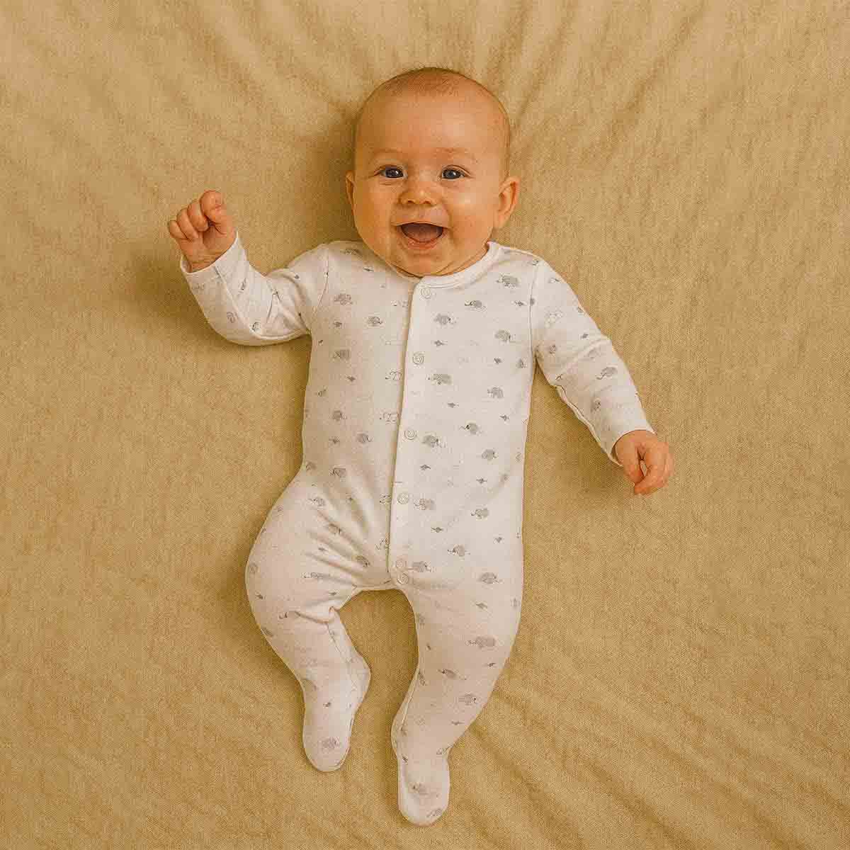 A toddler is wearing a Little Elephant Moonlight Sleepsuit