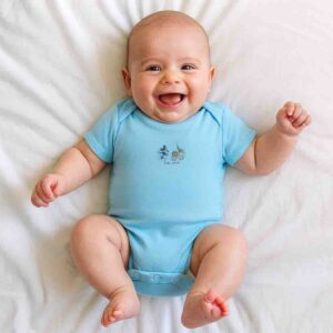 A toddler is wearing a mickey and friends adventure baby bodysuit