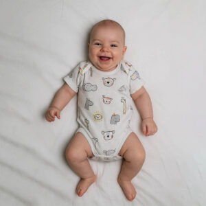 A toddler is wearing a safari classic baby bodysuit