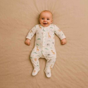 A toddler is wearing a Soft Trails Safari Sleepsuit