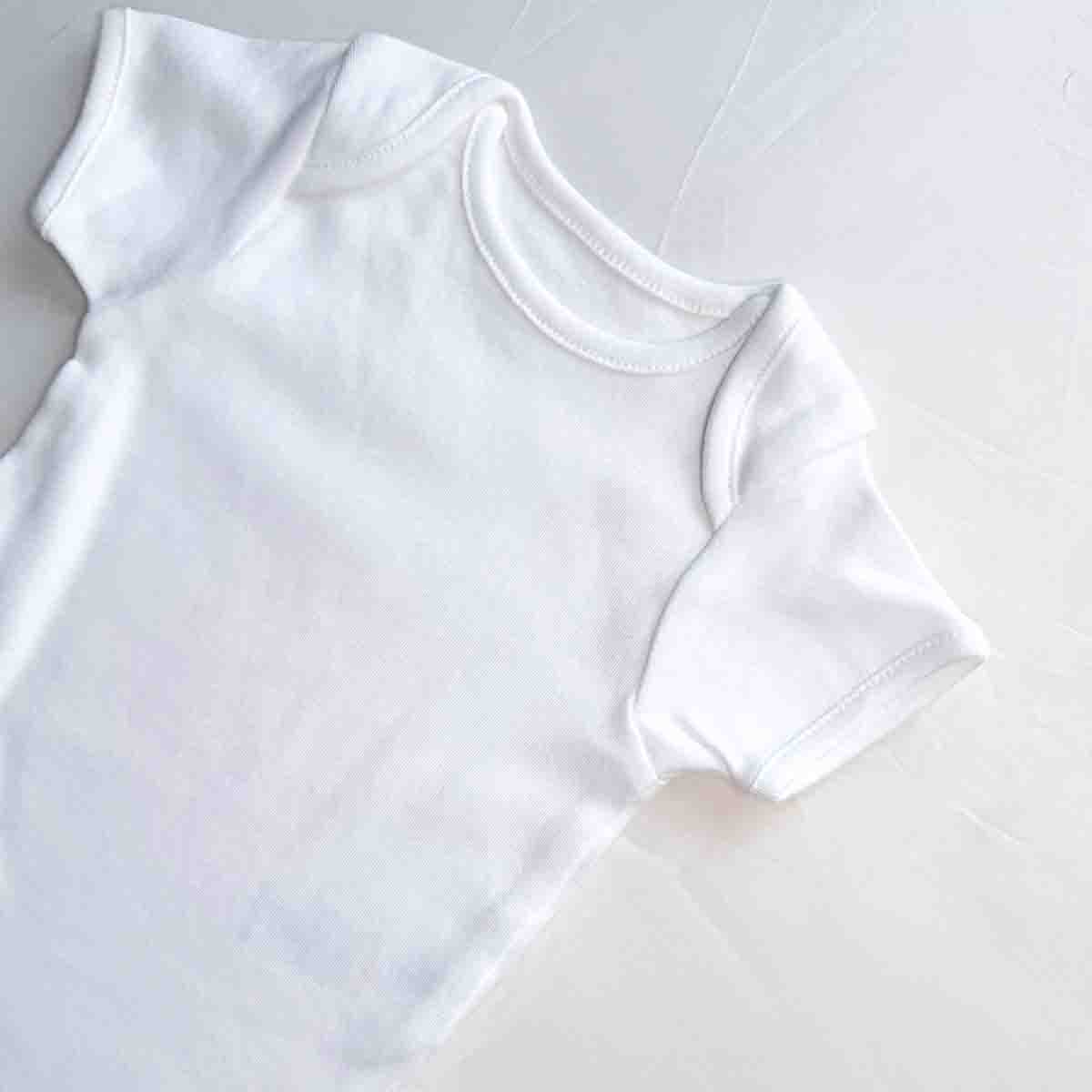 Pure cotton white baby bodysuit close-up view
