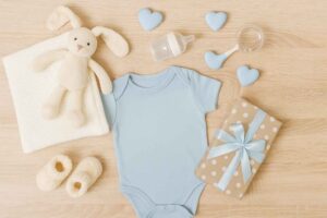 top 10 baby shower gift ideas - Baby items arranged on a neutral background