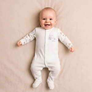 A toddler is wearing a Born in 2023 Keepsake Sleepsuit