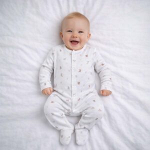 A toddler is wearing a Bunny Bloom Sleepsuit