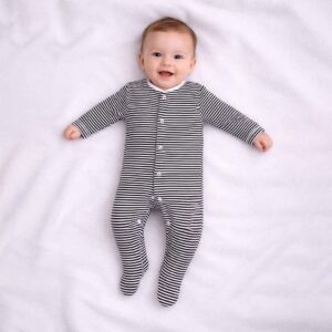 A toddler is wearing a Classic Noir Stripe Sleepsuit