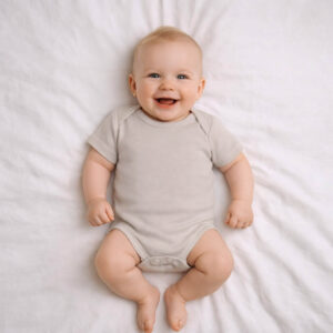 A toddler is wearing a Desert Whisper Bodysuit