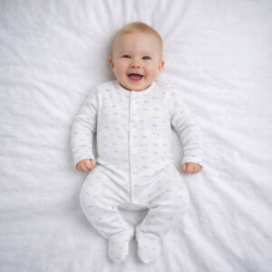 A toddler is wearing Happy Wheels Sleepsuit