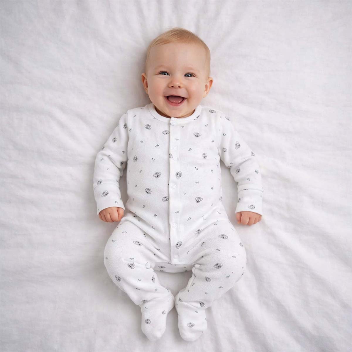 A toddler is wearing a Little Koala Cuddles Sleepsuit