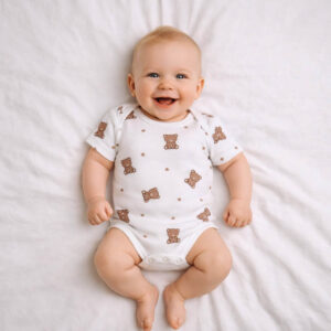 A toddler is wearing a Little Teddy Dreams Bodysuit