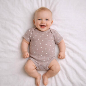 A toddler is wearing a Moonlit Stars Bodysuit