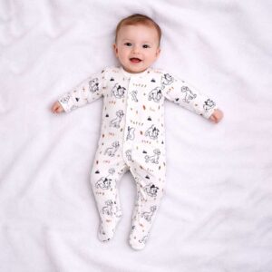 A toddler is wearing a Playful Pups Sleepsuit