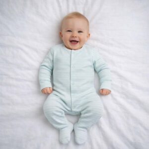 A toddler is wearing a Pure Mint Stripe Sleepsuit