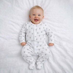 A toddler is wearing a Snuggle Bear Sleepsuit