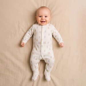 A toddler is wearing a Teddy Cuddle Sleepsuit
