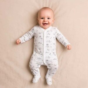 A toddler is wearing a Woodland Whispers Sleepsuit