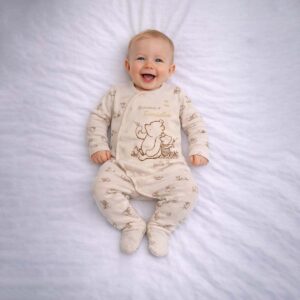 Baby wearing a baby bear friends sleepsuit with soft beige fabric and cute character design