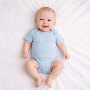 Baby wearing a baby blue bodysuit with soft fabric and clean minimal design