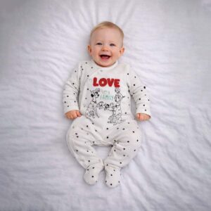 Baby wearing a baby dog family sleepsuit with cute family illustration and dot sleeves