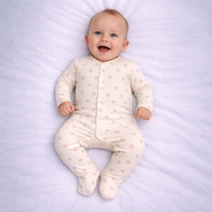 Baby floral sleepsuit with pink flower print on a soft cream background