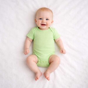 Baby wearing a baby green bodysuit with soft fabric and minimal design