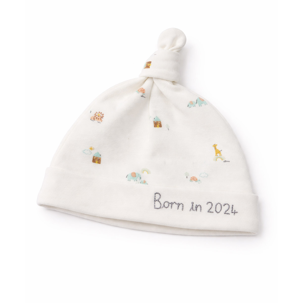 Cream newborn born in 2024 hat with gentle prints in studio flat lay