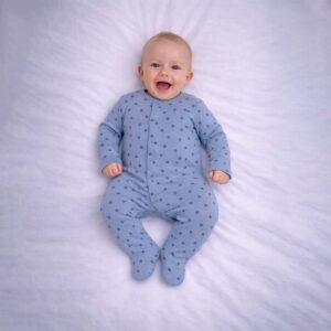 Baby wearing a baby triangle print sleepsuit with soft blue fabric and geometric pattern