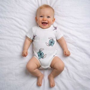 Blue icon print baby bodysuit worn by a baby during everyday wear