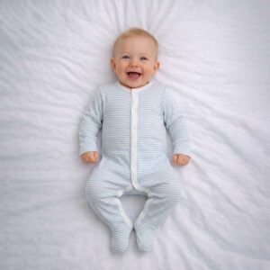 Blue striped baby sleepsuit worn by baby showing soft blue and white stripes