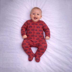 Car print baby sleepsuit worn by baby showing playful all over car design