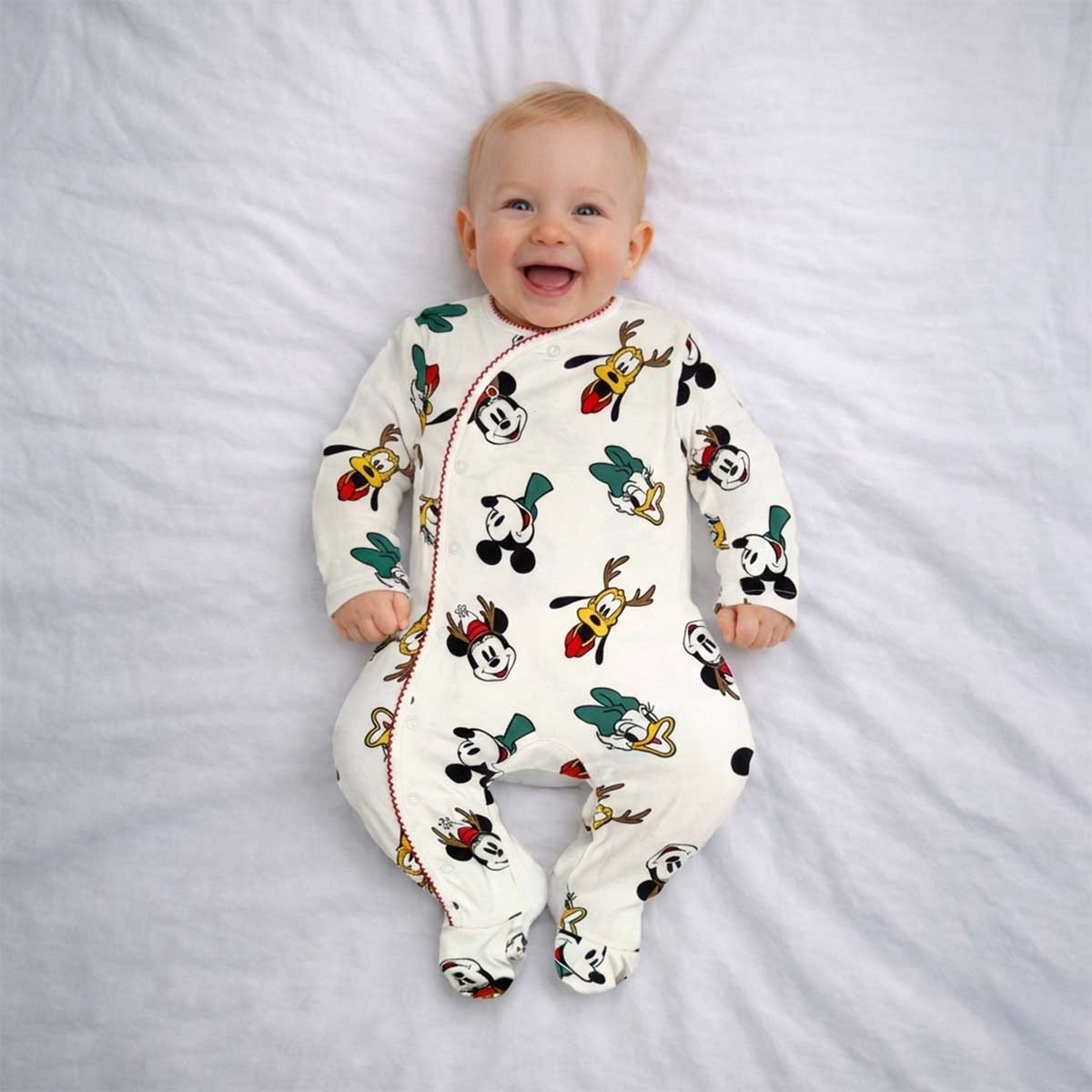 Cream baby sleepsuit with cartoon character print