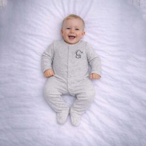 Elephant baby sleepsuit worn by baby showing cute elephant design and soft grey fabric