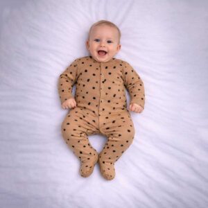 Geometric print baby sleepsuit worn by baby showing modern abstract pattern
