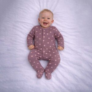Mauve baby sleepsuit with polka dot pattern