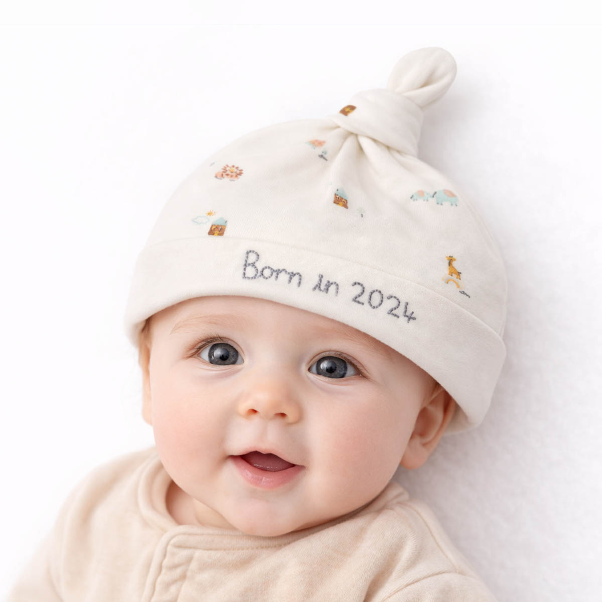 Newborn born in 2024 hat worn by baby with soft animal print design
