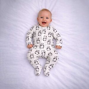 Panda print baby sleepsuit worn by baby showing cute all over panda design