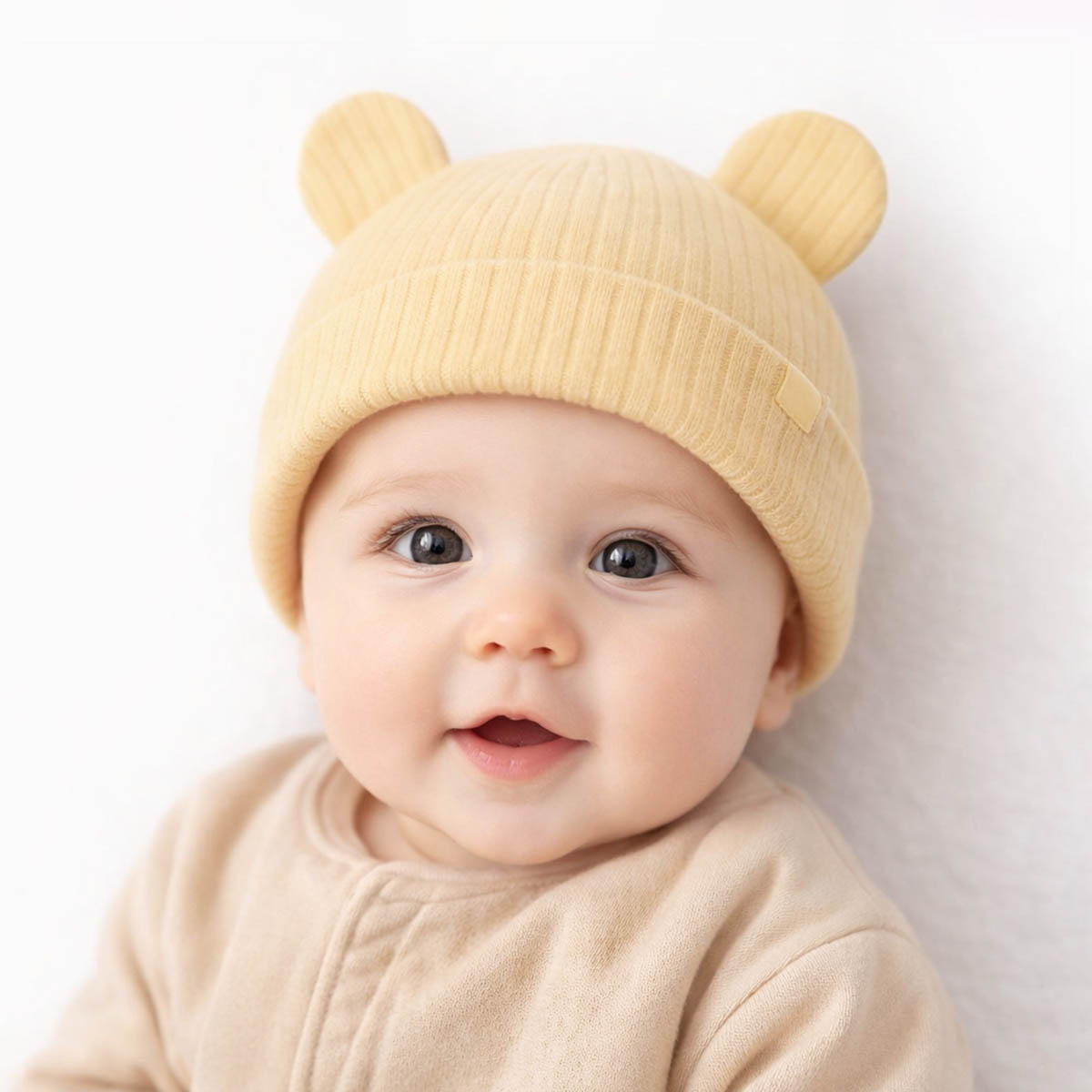 Yellow newborn hat with soft ribbed fabric and cute bear ears